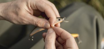 person-fixing-fish-hook